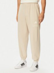 Adidas Spodnie dresowe Seasonal Essentials Collegiate French Terry Cuffed KF4265 Beżowy Regular Fit. Brązowe spodnie sportowe męskie Adidas, l, bez wzorów, z bawełny. Za 239.99 zł.