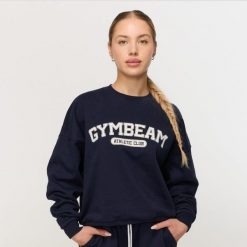 Bluza damska fitness bez kaptura niebieska Varsity. Niebieskie bluzy damskie GYMBEAM, s, bez wzorów, z bawełny, klasyczne, bez ramiączek, bez kaptura. Za 139.90 zł.