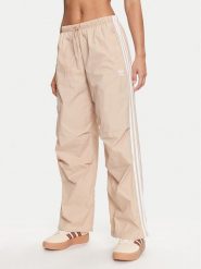 Adidas Spodnie dresowe 3-Stripes Woven Parachute IY7252 Beżowy Loose Fit. Brązowe spodnie dresowe damskie Adidas, bez wzorów, z dresówki. Za 269.99 zł.