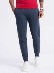 Spodnie męskie dresowe typu jogger - granatowe V4. Niebieskie spodnie sportowe męskie Ombre Clothing, m, bez wzorów, z bawełny. W wyprzedaży za 101.24 zł.