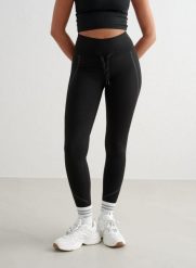 Damskie legginsy, wysoki stan, odprowadzające pot, odblaskowe, ocieplane czarne. Czarne legginsy damskie Aim'n, bez wzorów, z elastanu. Za 247.65 zł.