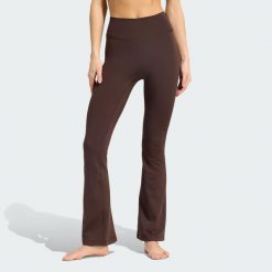Legginsy All Me Essentials Flare. Niebieskie legginsy damskie Adidas, bez wzorów, z dzianiny. Za 239.00 zł.