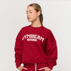 Bluza damska fitness bez kaptura czerwona Varsity. Czerwone bluzy damskie GYMBEAM, m, bez wzorów, z bawełny, klasyczne, bez ramiączek, bez kaptura. Za 139.90 zł.
