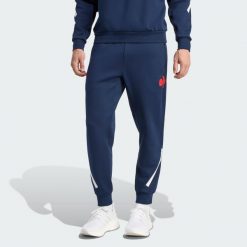 Spodnie France Travel. Niebieskie spodnie sportowe męskie Adidas, bez wzorów, z dresówki, do piłki nożnej. Za 439.00 zł.