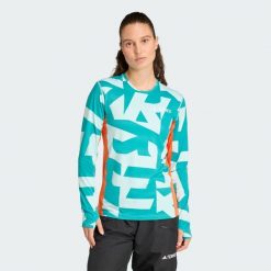 Koszulka z długim rękawem Multi Synthetic Base Layer. Brązowe bluzki damskie Adidas, s, bez wzorów, sportowe, bez kołnierzyka, bez ramiączek. W wyprzedaży za 142.35 zł.