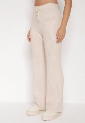 Jasnobeżowe Prążkowane Spodnie z Wełną o Szerokim Kroju z Wysokim Stanem Reinnia. Brązowe spodnie materiałowe damskie Born2be, bez wzorów, z jeansu, z podwyższonym stanem. Za 79.99 zł.