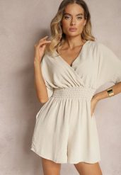 Beżowy Kombinezon Kopertowy z Gumką w Pasie Fandrea. Brązowe sukienki damskie Renee, bez wzorów, z jeansu, eleganckie, bez kołnierzyka, bez ramiączek, kopertowe. Za 44.99 zł.