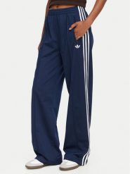 Adidas Spodnie dresowe Firebird KV5403 Niebieski Loose Fit. Niebieskie spodnie dresowe damskie Adidas, bez wzorów, z dresówki. Za 299.99 zł.