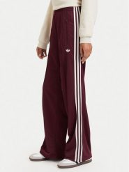 Adidas Spodnie dresowe Adicolor Classic Firebird KA7743 Brązowy Loose Fit. Brązowe spodnie dresowe damskie Adidas, bez wzorów, z dresówki. Za 299.99 zł.