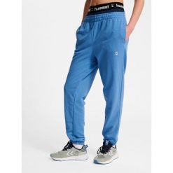 Damskie spodnie dresowe Hummel Pulse. Niebieskie spodnie dresowe damskie Hummel, bez wzorów, z dresówki, sportowe, na fitness i siłownię. Za 170.00 zł.