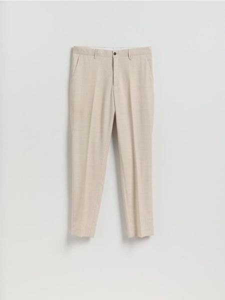 Garniturowe spodnie slim fit - beżowy. Brązowe garnitury męskie Reserved, l, bez wzorów, z tkaniny. W wyprzedaży za 119.99 zł.
