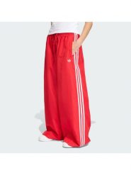 Adidas Spodnie dresowe Firebird Adilenium KD6299 Czerwony Regular Fit. Czerwone spodnie dresowe damskie Adidas, bez wzorów, z dresówki. Za 399.99 zł.