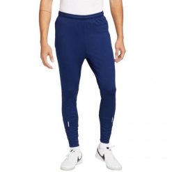 Męskie Spodnie Do Biegania ThermaFit Strike. Niebieskie spodnie sportowe męskie Nike, m, bez wzorów, do biegania. Za 352.99 zł.