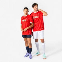 Koszulka piłkarska dla kibiców Tunezja 2026. Czerwone bluzki damskie KIPSTA, l, bez wzorów, z materiału, sportowe, bez kołnierzyka, bez ramiączek. Za 44.99 zł.