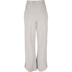 Spodnie z rozcięciem dla kobiet Urban Classics Heavy Terry Garment Dye GT. Szare spodnie dresowe damskie Urban Classics, bez wzorów, sportowe, długie. Za 275.00 zł.