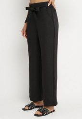 Czarne Spodnie o Szerokim Kroju z Wiązaniem i Gumką w Pasie Miravenia. Czarne spodnie materiałowe damskie Born2be, bez wzorów, z jeansu, eleganckie. Za 39.99 zł.