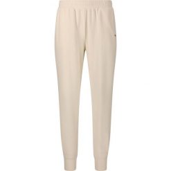 Damskie spodnie dresowe Athlecia Hecey. Białe spodnie dresowe damskie Athlecia, bez wzorów, z dresówki, sportowe, na fitness i siłownię. Za 197.50 zł.