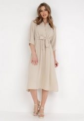 Beżowa Sukienka Rheniolea. Brązowe sukienki damskie Born2be, m, bez wzorów, eleganckie, bez kołnierzyka, bez ramiączek, midi, kopertowe. Za 79.99 zł.