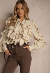 Beżowa Koszula z Wiskozą Zdobiona Falbanami i Wiązaniem przy Szyi Ravissa. Brązowe koszule damskie Renee, m, z aplikacjami, z wiskozy, eleganckie, bez kołnierzyka, bez ramiączek. Za 159.99 zł.
