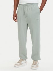 Tommy Hilfiger Spodnie dresowe Essential UM0UM03911 Zielony jasny Relaxed Fit. Zielone spodnie sportowe męskie Tommy Hilfiger, m, bez wzorów, z bawełny. Za 289.99 zł.