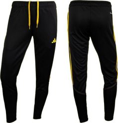 Adidas Spodnie damskie adidas Tiro 23 Club Training czarno-żółte IC1602 L. Czarne spodnie dresowe damskie Adidas, bez wzorów, sportowe. Za 142.07 zł.