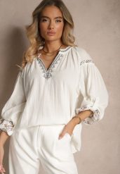 Biała Bluzka z Bawełny Ozdobiona Haftem Isdexira. Białe bluzki damskie Renee, l, bez wzorów, z bawełny, eleganckie, bez kołnierzyka, bez ramiączek. Za 64.99 zł.