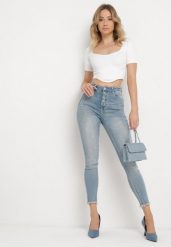Niebieskie Jeansy Skinny z Postrzępionymi Nogawkami Odettema. Niebieskie jeansy damskie Born2be, bez wzorów, z jeansu, eleganckie. Za 99.99 zł.