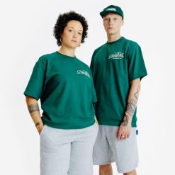 Koszulka z grafiką. Zielone bluzki damskie Decathlon, xl, bez wzorów, z bawełny, bez kołnierzyka, bez ramiączek. W wyprzedaży za 59.99 zł.