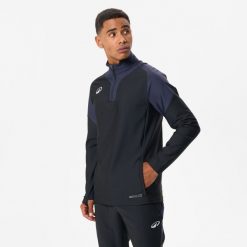 Bluza piłkarska Kipsta Viralto Club na krótki suwak. Czarne bluzy męskie KIPSTA, m, bez wzorów, z elastanu, sportowe, bez ramiączek, bez kaptura. Za 99.99 zł.