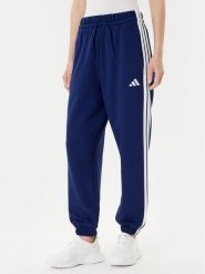 Adidas Spodnie dresowe Essentials 3-Stripes Fleece JX7696 Niebieski Loose Fit. Niebieskie spodnie dresowe damskie Adidas, bez wzorów, z bawełny. Za 159.99 zł.