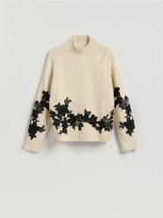 Sweter z ozdobną aplikacją - kremowy. Białe swetry nierozpinane damskie Reserved, l, z aplikacjami, z dzianiny, bez kołnierzyka, bez ramiączek. Za 159.99 zł.