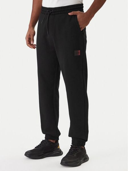 HUGO Spodnie dresowe Danopan 50553146 Czarny Relaxed Fit. Czarne spodnie sportowe męskie Hugo, l, bez wzorów, z bawełny. Za 549.99 zł.