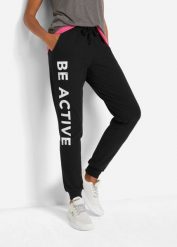 Spodnie sportowe bawełniane z nadrukiem, Loose Fit. Czarne spodnie dresowe damskie bonprix, bez wzorów, z bawełny, sportowe, na fitness i siłownię. Za 114.99 zł.
