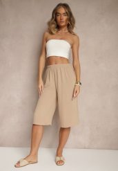 Beżowe Luźne Spodnie 3/4 z Kieszonkami Efrinea. Brązowe spodnie materiałowe damskie Renee, bez wzorów, z gumy, eleganckie. Za 29.99 zł.