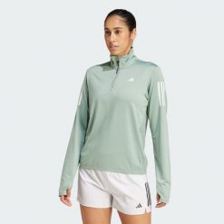 Kurtka Own the Run Half-Zip. Zielone kurtki sportowe damskie Adidas, m, bez wzorów, z materiału, bez ramiączek, bez kaptura, do biegania. Za 208.40 zł.