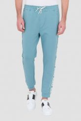 GUESS Turkusowe dresowe spodnie New Arlo. Niebieskie spodnie sportowe męskie Guess, l, z aplikacjami, z dresówki. W wyprzedaży za 259.99 zł.
