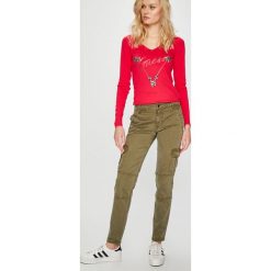 Guess Jeans - Spodnie Caroline. Zielone spodnie materiałowe damskie Guess Jeans, bez wzorów, z bawełny, casualowe, z obniżonym stanem. W wyprzedaży za 379.90 zł.