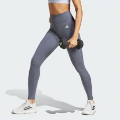 Długie legginsy Optimé Essentials z kieszonką na drobiazgi. Białe bielizna sportowa damska Adidas, bez wzorów. Za 199.00 zł.