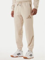 Adidas Spodnie dresowe Z.N.E. KE4684 Beżowy Regular Fit. Brązowe spodnie sportowe męskie Adidas, m, bez wzorów, z bawełny. Za 399.99 zł.