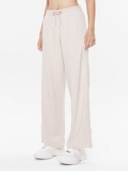 Tommy Hilfiger Spodnie dresowe UW0UW04771 Beżowy Relaxed Fit. Brązowe spodnie dresowe damskie Tommy Hilfiger, bez wzorów, z dresówki. Za 199.99 zł.