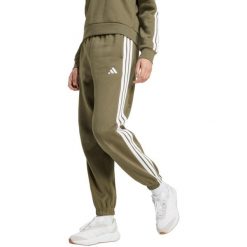 Spodnie damskie adidas Essentials 3-Stripes Fleece Loose-Fit. Zielone spodnie materiałowe damskie Adidas, bez wzorów, z bawełny, sportowe. Za 171.99 zł.
