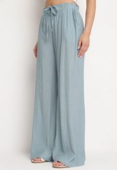 Jasnoniebieskie Szerokie Spodnie z Wiskozy Zyona. Niebieskie spodnie materiałowe damskie Born2be, bez wzorów, z jeansu, eleganckie. Za 59.99 zł.