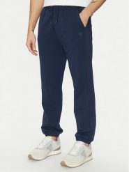 Guess Spodnie dresowe Z5GB06 K6ZS1 Granatowy Regular Fit. Niebieskie spodnie sportowe męskie Guess, m, z aplikacjami, z bawełny. Za 207.00 zł.