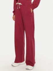 Champion Spodnie dresowe 117638 Czerwony Wide Leg. Czerwone spodnie dresowe damskie Champion, bez wzorów, z bawełny. Za 159.99 zł.