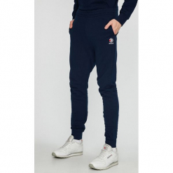 Reebok Classic - Spodnie. Niebieskie spodnie materiałowe męskie Reebok Classic, bez wzorów, z bawełny. W wyprzedaży za 159.90 zł.