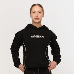 Bluza damska fitness z kapturem czarna Varsity. Czarne bluzy damskie GYMBEAM, m, bez wzorów, z bawełny, klasyczne, bez ramiączek, z kapturem. Za 139.90 zł.