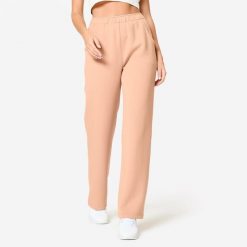 Spodnie dresowe damskie Domyos Gym & Pilates. Brązowe spodnie dresowe damskie Decathlon, bez wzorów, z dresówki, eleganckie. Za 119.99 zł.