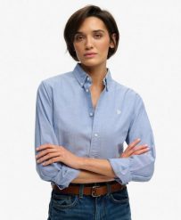 Superdry Damska Koszula Slim Oxford z Długim Rękawem z Bawełny Organicznej. Niebieskie koszule damskie Superdry, bez wzorów, z bawełny, bez kołnierzyka, bez ramiączek. Za 314.00 zł.