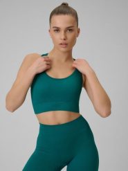4F Biustonosz treningowy bezszwowy z niskim wsparciem damski - turkusowy XS/S. Niebieskie bielizna sportowa damska 4F, s, bez wzorów, z materiału. Za 89.99 zł.