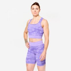 Koszulka fitness damska Domyos crop top. Fioletowe bluzki damskie DOMYOS, l, bez wzorów, z elastanu, sportowe, bez kołnierzyka, bez ramiączek. Za 89.99 zł.